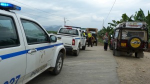 three police cars full with curious caps